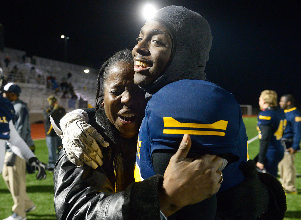 Tasca McHenry-Tolson cries as she hugs her son